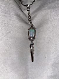 a silver keychain with a turquoise stone on it