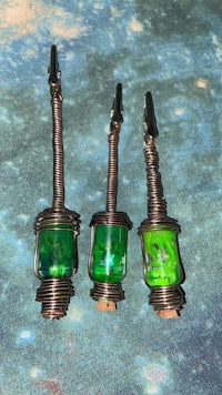 three green glass jars on a table